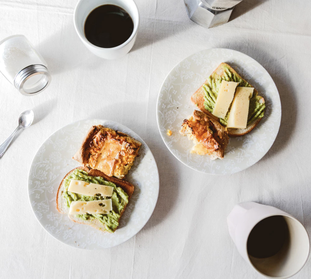 A breakfast with avocado eggs and coffee